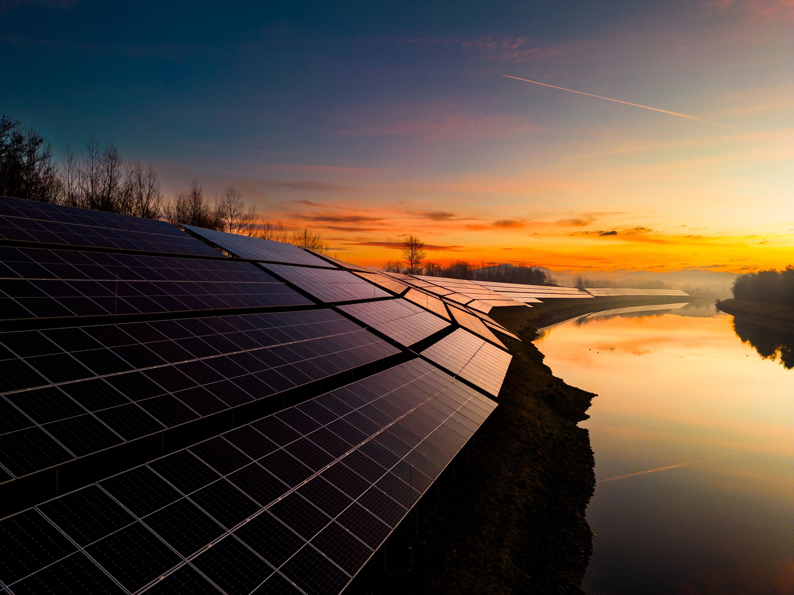 Solar power station with panel arrays at sunset